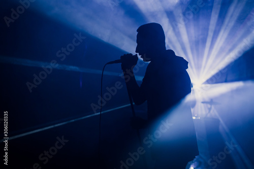 rock concert silhouette musician performance on stage song music drive frontman band light guitar microphone singer