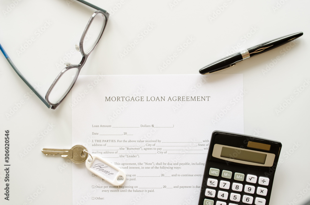 Mortgage loan agreement contract, concept with calculator, keys and pen on mortgage form or contract. Top view. Mortgage loan agreement contract, concept with calculator, keys and pen on mortgage form or contract. Top view.