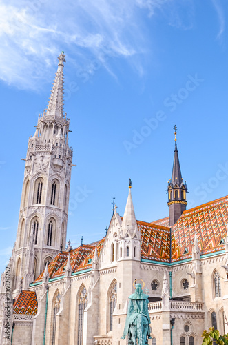 Tower of the Matthias Church in Budapest, Hungary on a vertical photo. Roman Catholic church in the Gothic style. Located in front of Fishermans Bastion in Buda Castle District. Tourist attraction