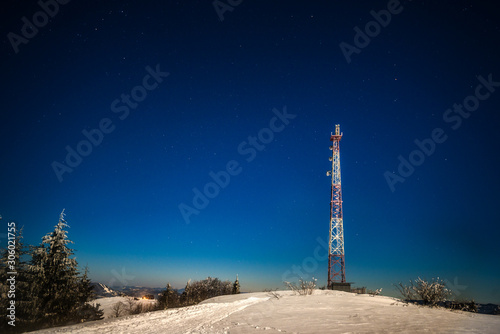 Tall observation tower stands on a snowy hill