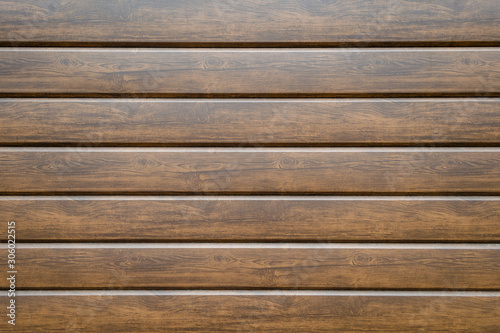 Wall from the boards covered with dark varnish. Texture, wooden background, backdrop.