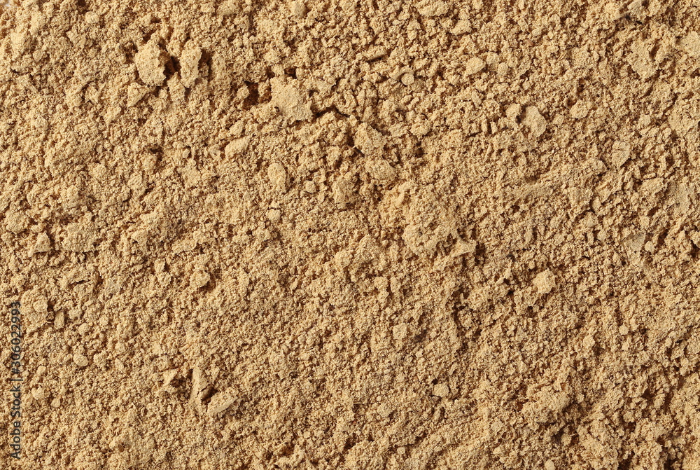 Ginger powder background and texture, top view