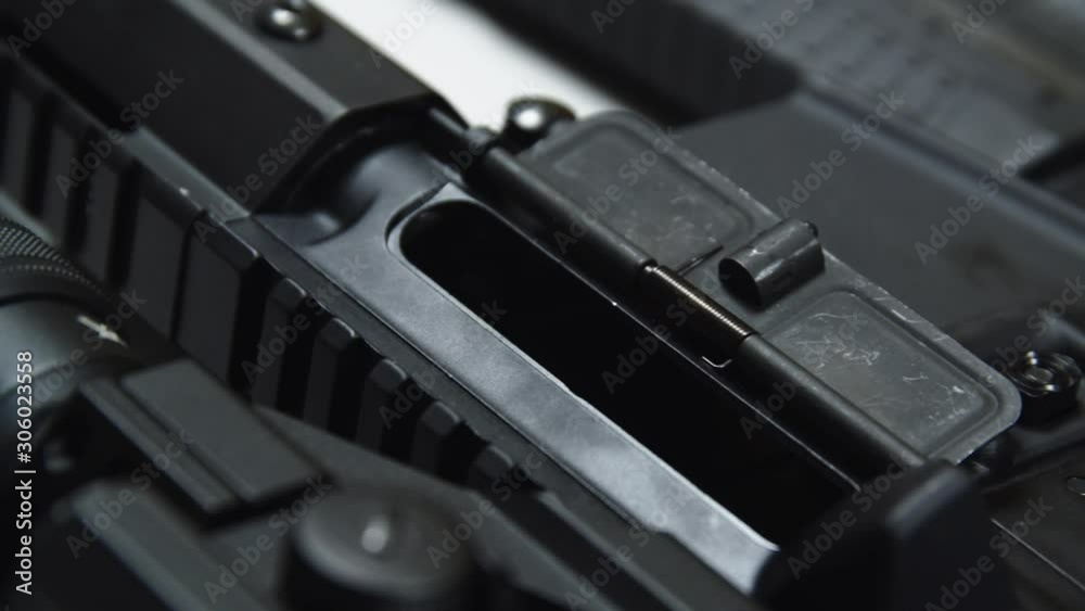 Close travelling shot of a tactical rifle with some ammunition. Close travelling shot of a tactical rifle with some ammunition.