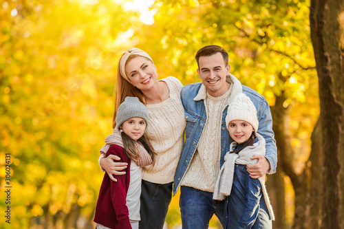 Portrait of happy family in autumn park