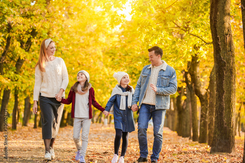 Happy family walking in autumn park © Pixel-Shot