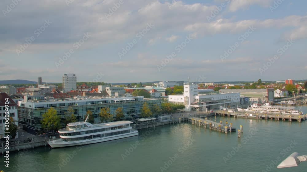 The cityscape on the lake old buildings and chapel on the shore high angle aerial view panorama pan shot The cityscape on the lake old buildings and chapel on the shore high angle aerial view panorama pan shot