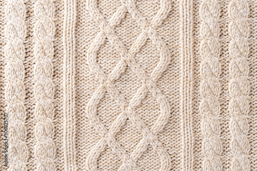 Beige Knitwear Fabric Texture with Pigtails. Beige Knitted Background.