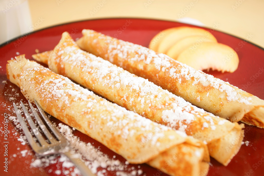Crepes (pancakes) with butter and powdered sugar.