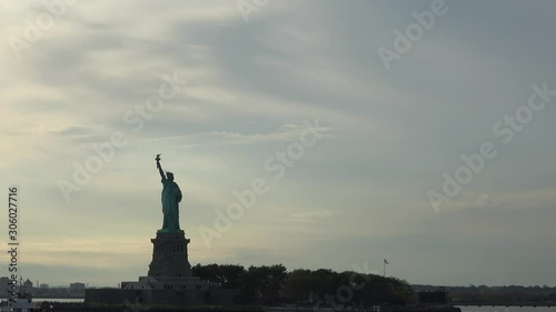 4K. Ultra HD. Zoom shot of the Statue of Liberty filmed at sunset from the East River, New York, United States of America. Statue of Liberty is one of the most famous monuments in New York.