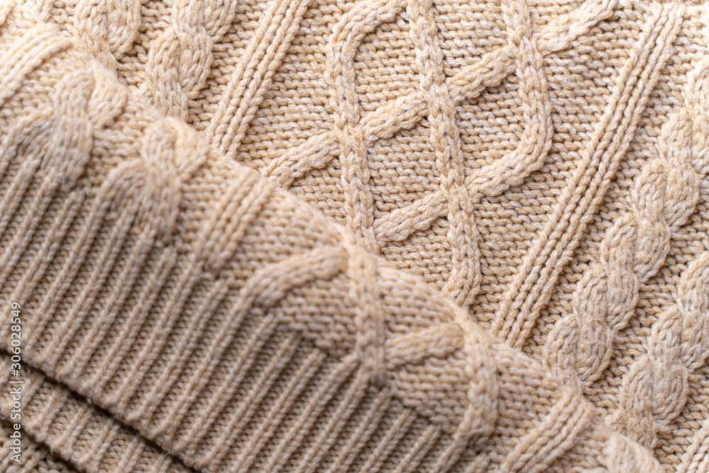 Beige Knitwear Fabric Texture with Pigtails. Beige Knitted Background. Beige Knitwear Fabric Texture with Pigtails. Beige Knitted Background.