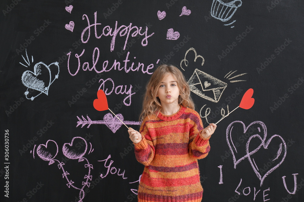 Cute little girl with paper hearts near dark wall. Valentines Day celebration