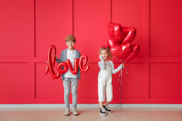 Cute little children with air balloons on color background. Valentines Day celebration