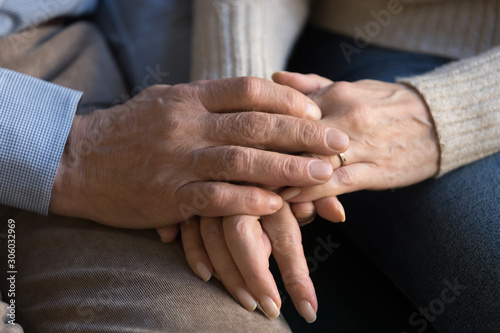Fototapeta Naklejka Na Ścianę i Meble -  Close up image of elderly couple holding hands