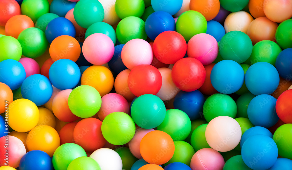 Many colorful plastic balls in a kids' ballpit at a playground, kind of toy for kids. Many colorful plastic balls in a kids' ballpit at a playground, kind of toy for kids.