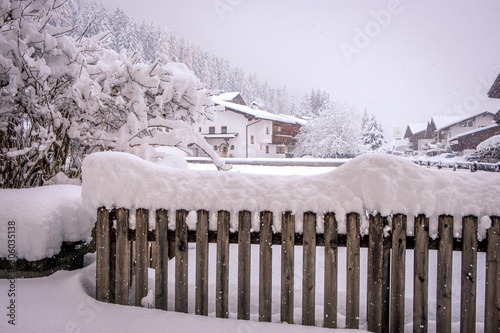 Winter landscape in the city of Neustift in the Stubai Valley in Austria. Snow covered fence after heavy snowfall