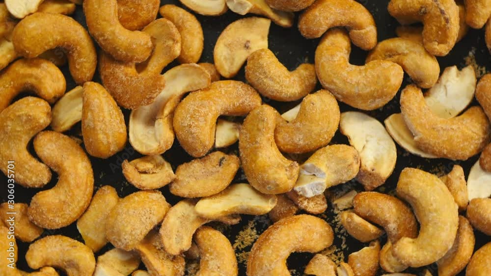 Salted Roasted Cashews Rotating On The Black Plate On Turntable Top View Salted Roasted Cashews Rotating On The Black Plate On Turntable Top View
