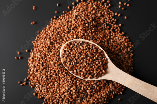Buckwheat in bulk and in a spoon on a dark background