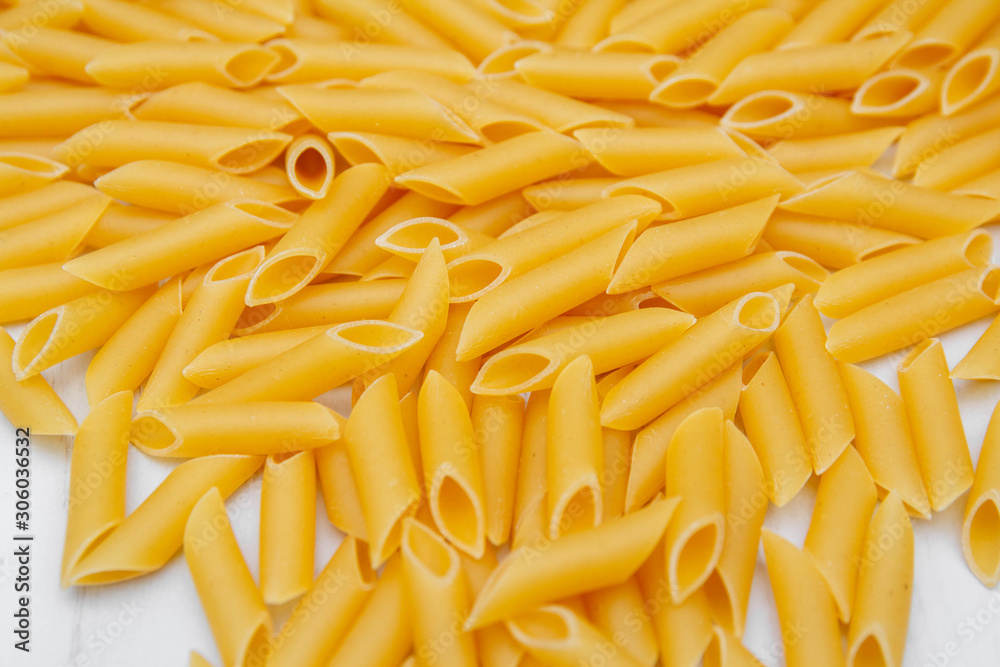 Pasta penne rigate on a white wooden table background. Top view, copy space Pasta penne rigate on a white wooden table background. Top view, copy space