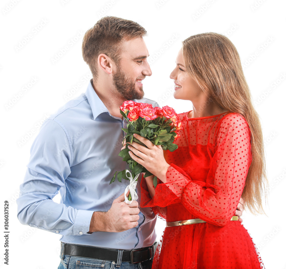 Happy young couple with bouquet of flowers on white background. Valentine's Day celebration Happy young couple with bouquet of flowers on white background. Valentine's Day celebration