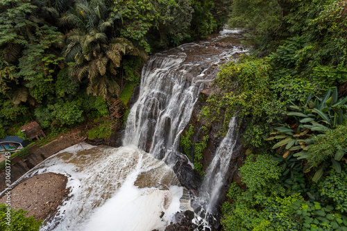 Aerial view of waterfalls surrounded by tropical trees (