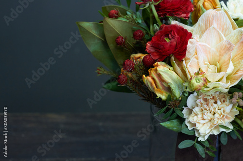 Detail closeup naked bouquet in vintage style in a glass vase on a dark background, selective focus photo