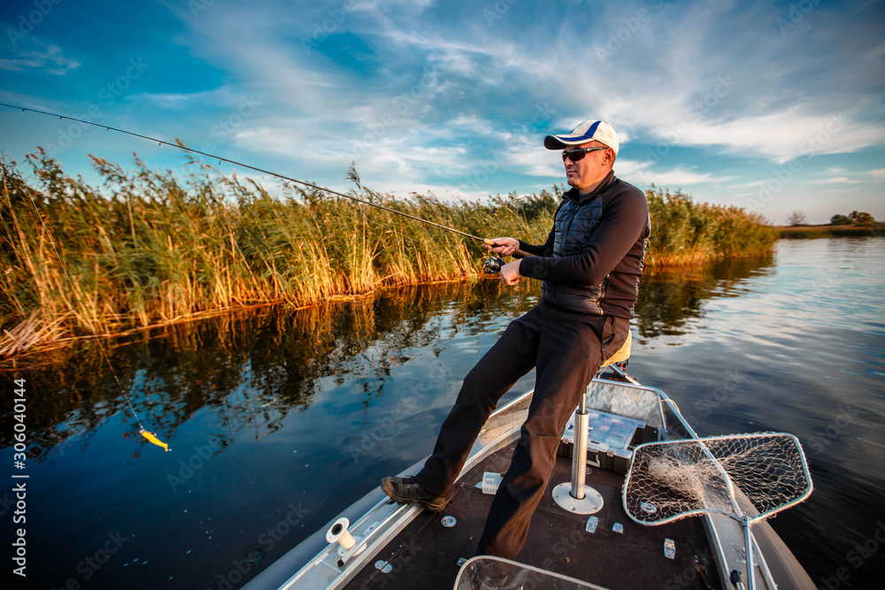 fisherman on a motor boat with spinning