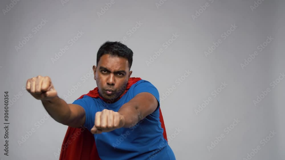 super power and people concept - flying indian man in red superhero cape over grey background