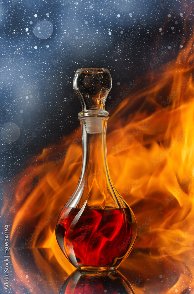 Whiskey in a decanter against a natural flame. Bokeh overlay Whiskey in a decanter against a natural flame. Bokeh overlay