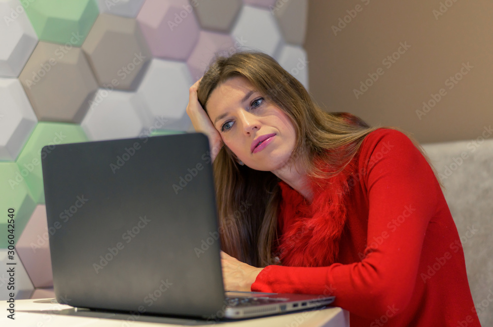 Fototapeta premium tired woman looking at laptop screen