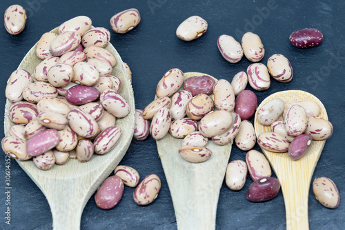 Bean pint or bean with wooden spoons on slate plate photo