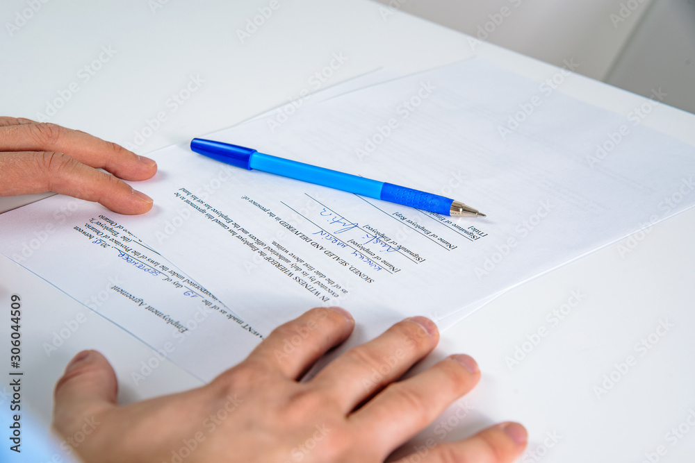 Signing contract. Business concept, hiring employees. The man signs the contract, signs the employment contract. Signature of the commitment. Signing contract. Business concept, hiring employees. The man signs the contract, signs the employment contract. Signature of the commitment.