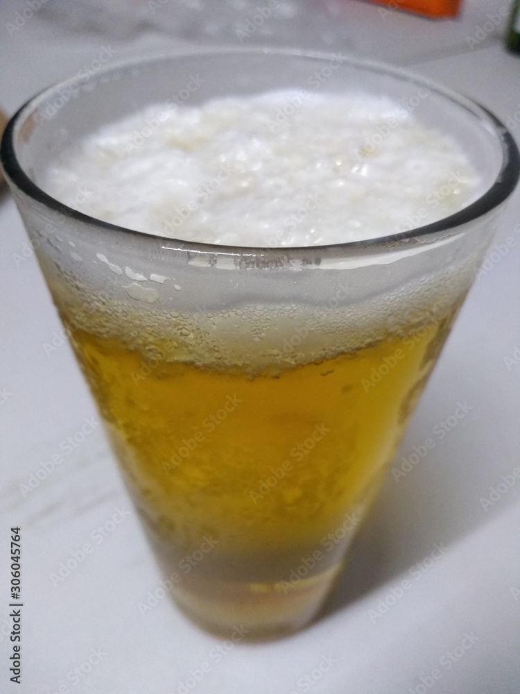 glass of cola with ice on a white background