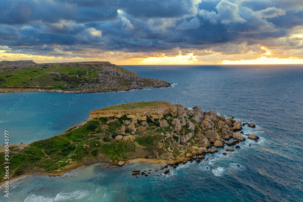 Aerial view of Ghajn Tuffieha Bay. Sunset sky, clouds, sea, winter. Europe. Malta island
