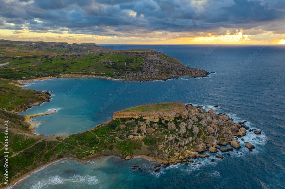 Aerial view of Ghajn Tuffieha Bay. Sunset sky, clouds, sea, winter. Malta country