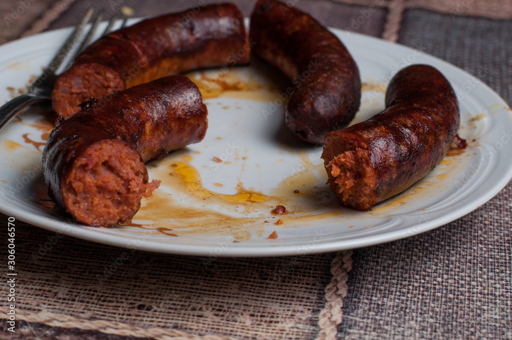 Roasted sausage in a plate on a table.Healthy food Roasted sausage in a plate on a table.Healthy food