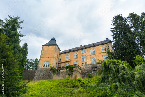 Old castle with tower on a grassy hillside, Europe