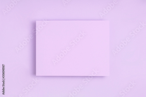 Minimal frame geometric composition mock up. Blank sheet of lilac paper postcard on delicate blue background. Template design invitation card. Top view, flat lay, copy space. Horizontal orientation.