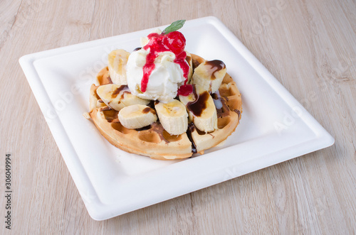 waffles with ice cream, chopped fruit and sauces