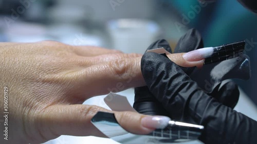 Acrylic Manicure. Master make nail extension. Acrylic nails in a beauty salon. The creation of extension nail salon technician.