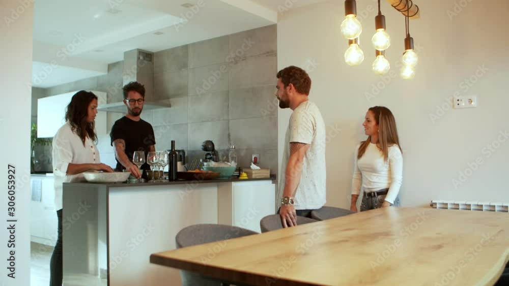 Focused young couple preparing glasses for wine. Cheerful young friends hanging out together. Hospitableness concept Focused young couple preparing glasses for wine. Cheerful young friends hanging out together. Hospitableness concept