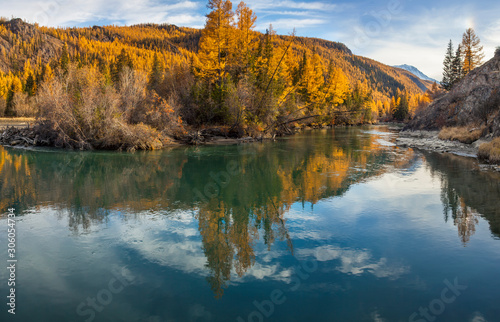 Wild mountain river, evening light. The calm flow of the river, forest shores. Wild place in Siberia.