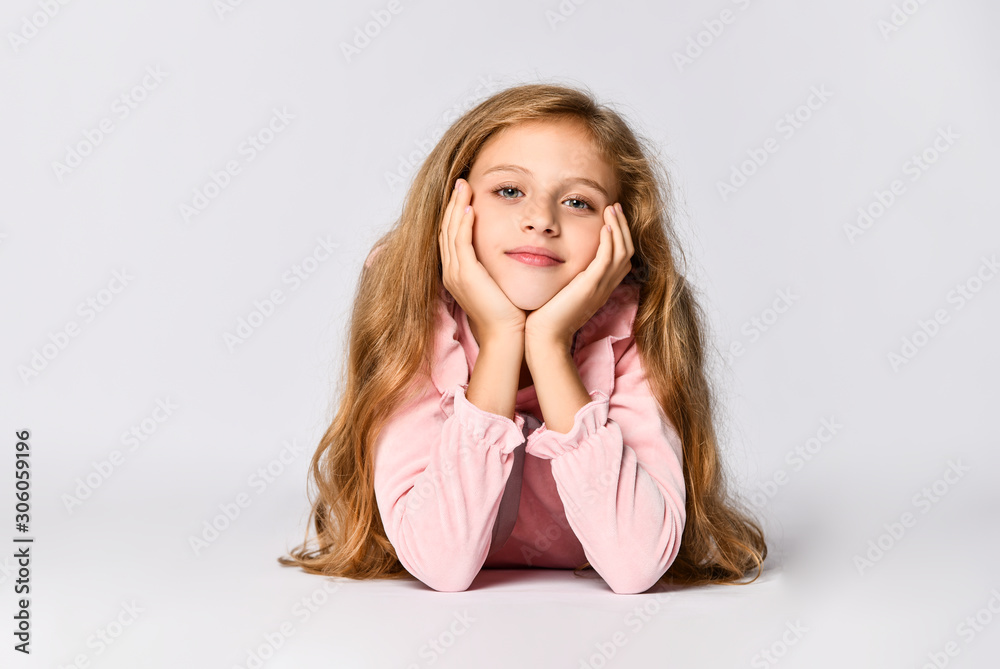 Portrait of a young woman lying on the floor isolated on white background
