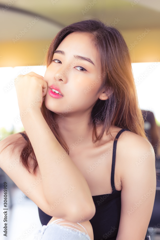 Portrait young asian woman. Beautiful asian lady has nice skin and beautiful face. Glamour Asia girl looks at camera, gets relaxed, happy. Charming beautiful young female is good looking women. Portrait young asian woman. Beautiful asian lady has nice skin and beautiful face. Glamour Asia girl looks at camera, gets relaxed, happy. Charming beautiful young female is good looking women.