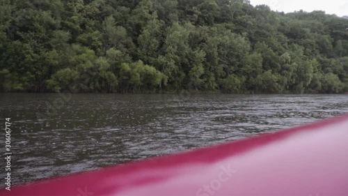 view from an inflatable boat to a mountain river with rain photo