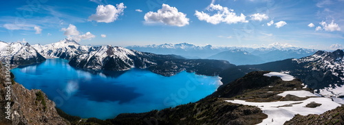 Panoramic view of mountains and turquoise coloured lake in Garibaldi provincial park, BC, Canada. snow mountains and blue sky. photo
