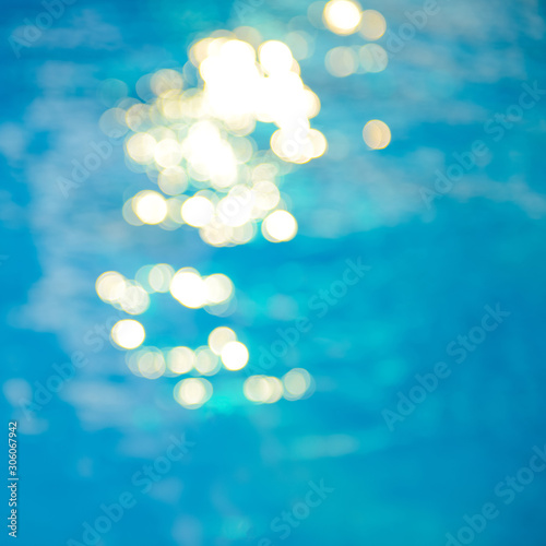 Bokeh light effects over a rippled, blue water background