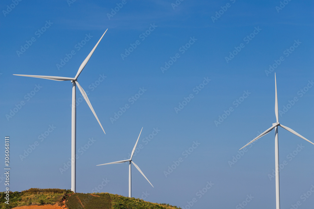 Wind turbine on hill with blue sky.Concept of clean eco power energy. Wind turbine on hill with blue sky.Concept of clean eco power energy.