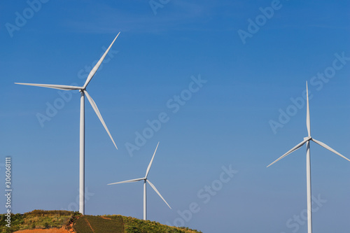 Wind turbine on hill with blue sky.Concept of clean eco power energy.