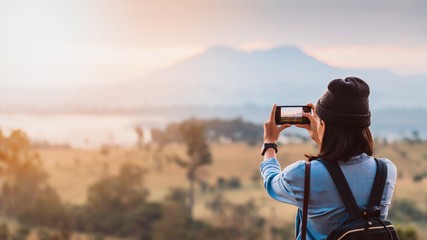 Traveler woman standing on the top of mountain in beautiful nature at North Thailand forest.Beautiful landscape for adventure travel.