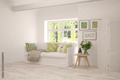 Stylish room in white color with sofa, table, pictures on a wall and summer landscape in window. Scandinavian interior design. 3D illustration © AntonSh